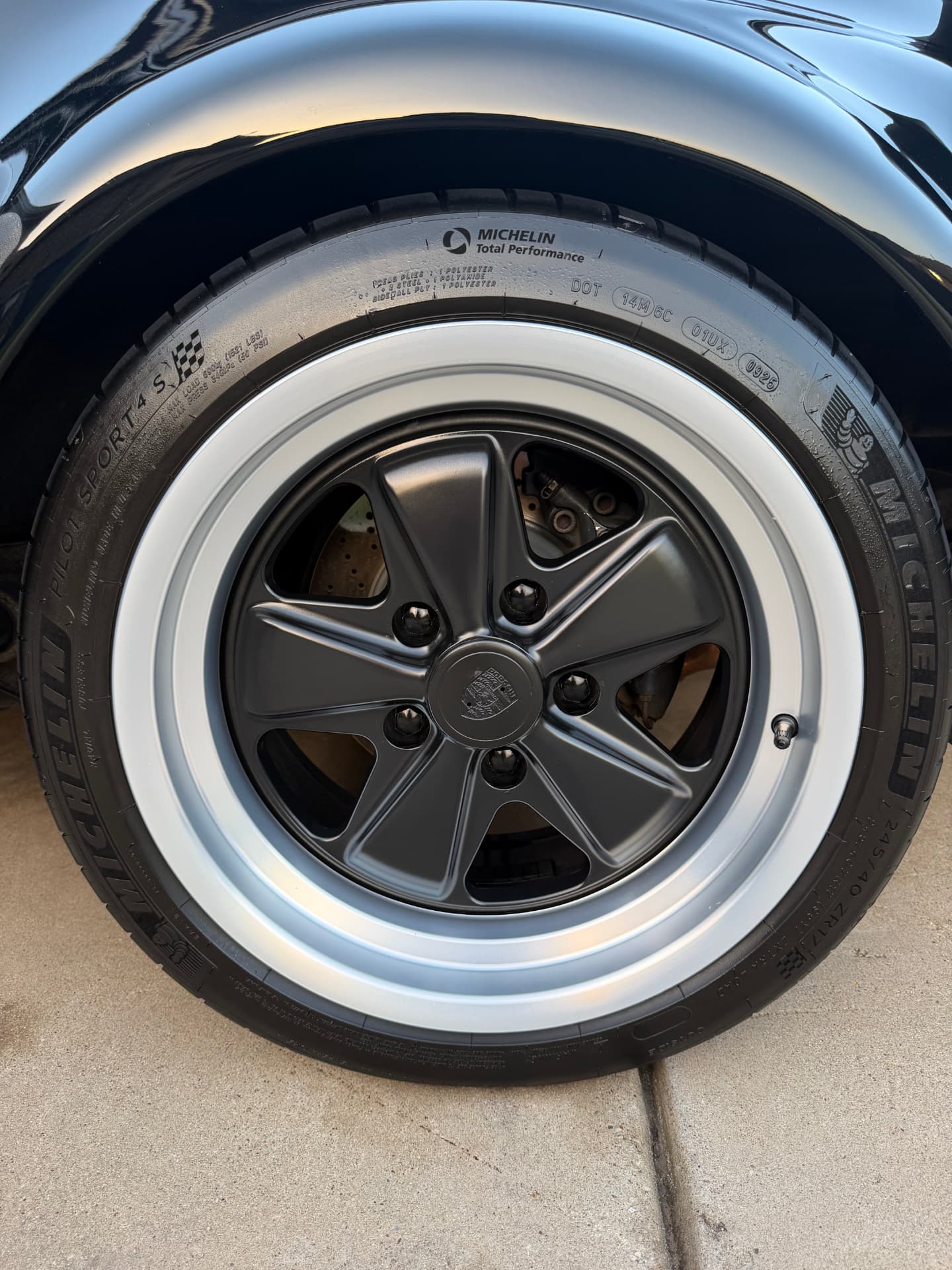 Detailed Porsche 911 wheel and Michelin tire after a full exterior detail
