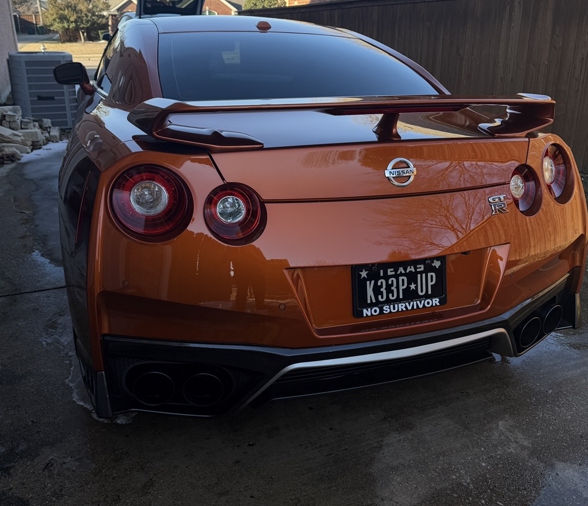 Orange Nissan GT-R rear end polished to a deep gloss